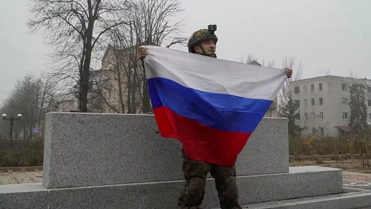Un militar ruso sostiene una bandera en la ciudad ucraniana de Pokrovsk