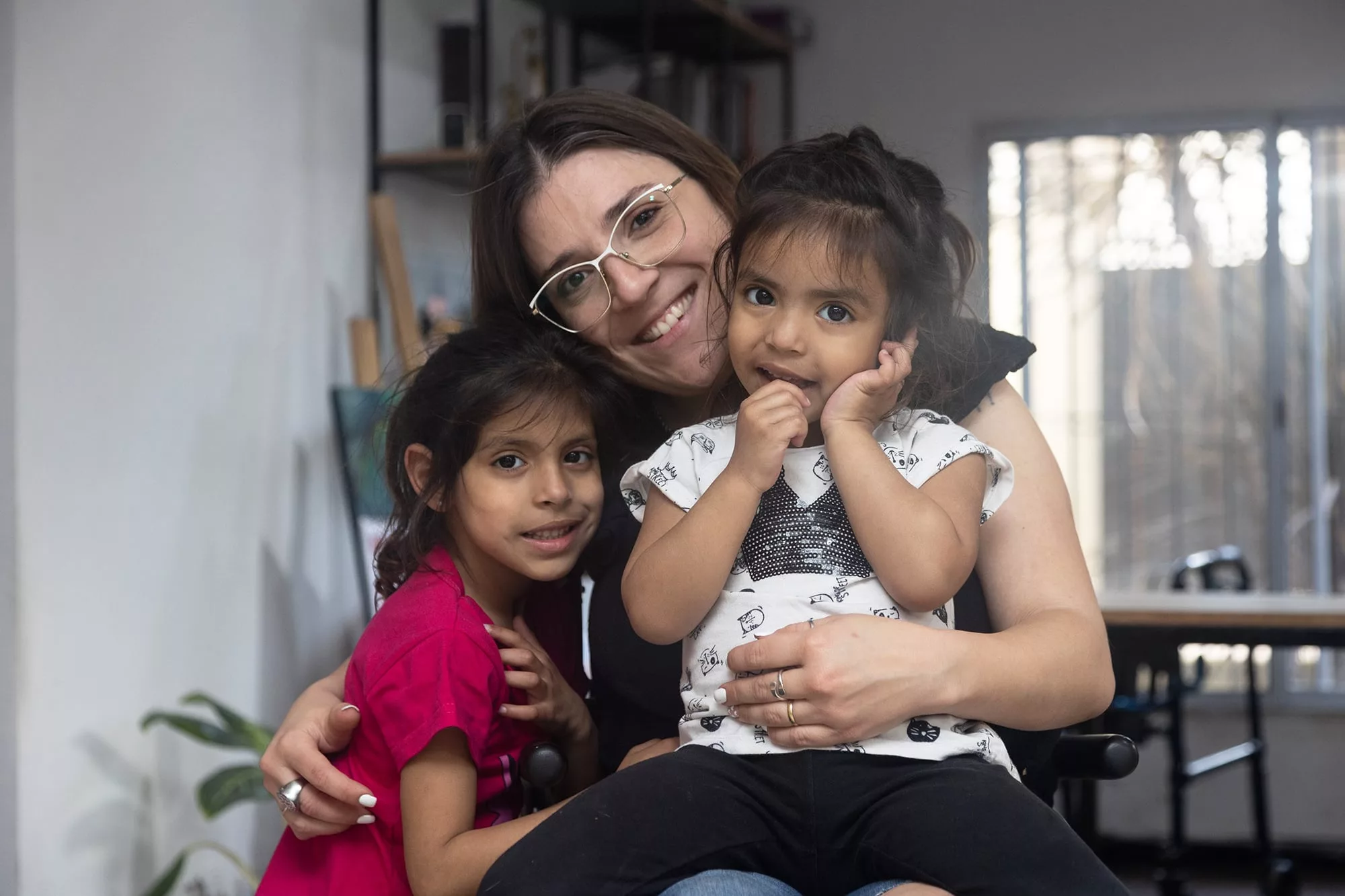 Rocío junto a sus hijas, Amaris (de rosa) y Oriana (en su falda). 